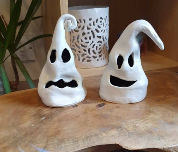 Two ghost faced lanterns made from clay.