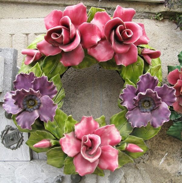 A Christmas wreath made of clay painted with pink and purple.