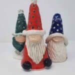 Three Christmas gonks in various sizes and colours.