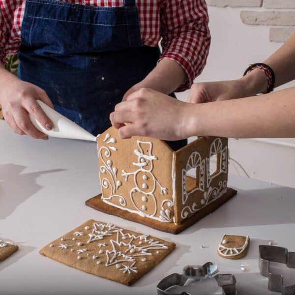 Two people making a Gingerbread House