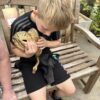 Child holding a royal python