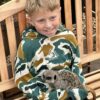 Child holding a meerkat